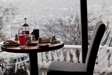 Breakfast for two in the cozy cafe on winter snowing morning. Ch