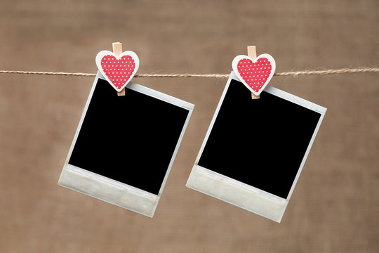 Two polaroid photo frames for valentines day on vintage backgrou