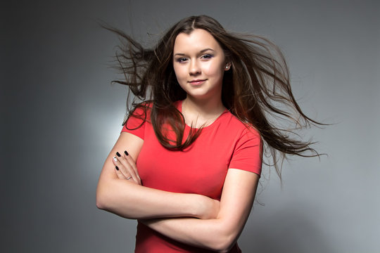 Girl With Flowing Hair And Arms Crossed