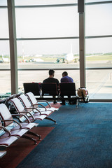 Business Couple at Eziza Airport. Modern Set up. Waiting.