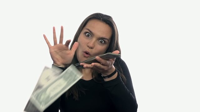 Woman flipping money on white background