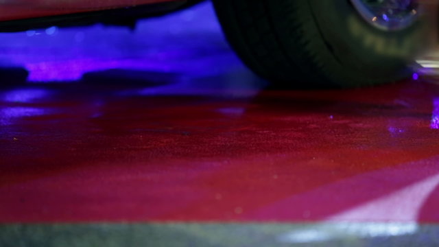 Woman in high heels stepping out of Corvette