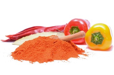 paprika powder and peppers on white background