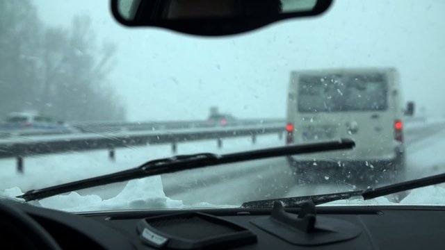 Following a van on a snowy highway
