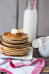 Pancake with butter, honey and milk, sweet breakfast
