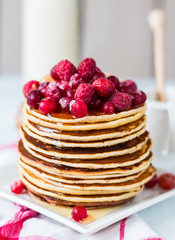 Pancake with cranberries, raspberries and honey, sweet