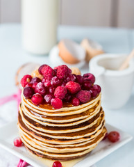 Pancake with cranberries, raspberries and honey, sweet