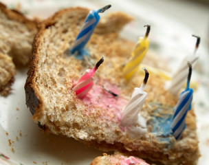 Improvised birthday cake made of candles on a toast.