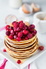Pancake with cranberries, raspberries and honey, sweet