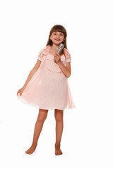 cute little girl singing into a microphone