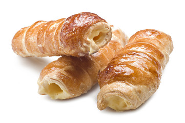 Italian cannoli filled with egg custard on white background