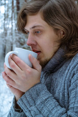 The long-haired man in a winter forest