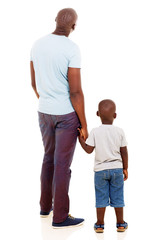rear view of young african man with his son