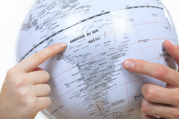 Fototapeta premium Excited young couple planning their holiday holding up a globe