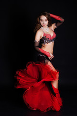 Beautiful belly dancer wearing a black costume