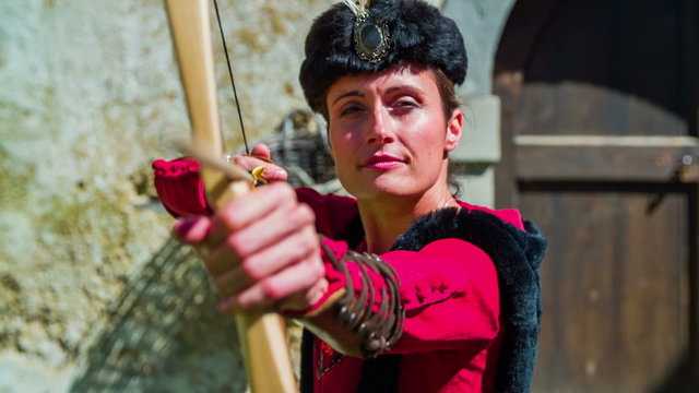 Castle princess shooting with historic bow