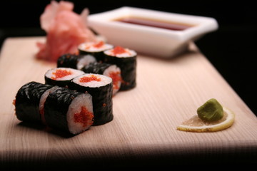 tasty sushi on black background