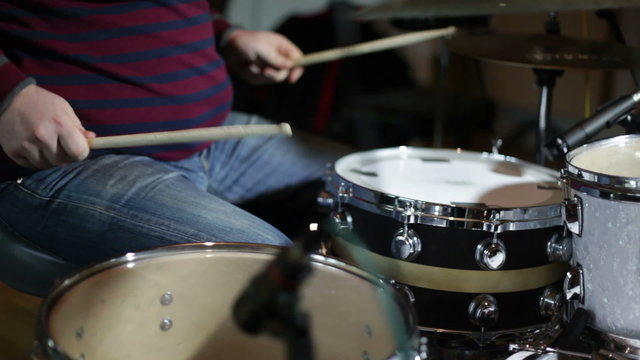 close up shot of musican playing drums