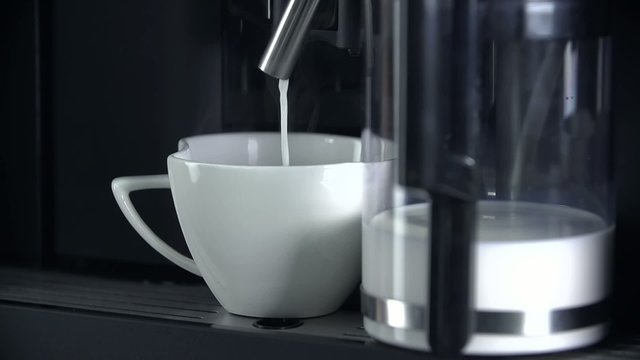 Pouring milk into the cup
