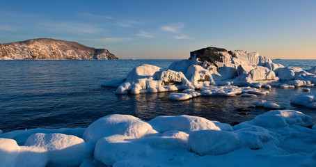 Stones covered with ice on the beach.