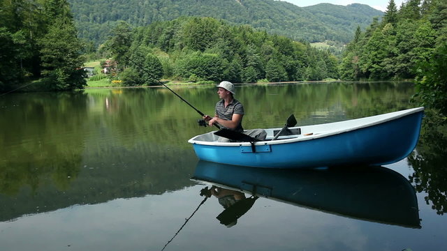 HD1080p: Young man fishing from a boat in a beautiful nature