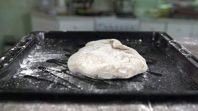 Dough falls into the black plate in slow motion