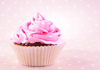 Delicious cupcake on beige background