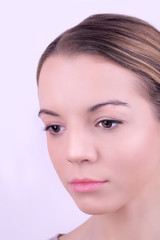 Applying makeup on female face, on white background