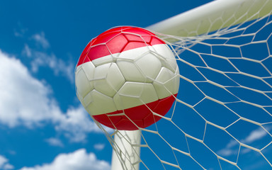 Naklejka premium Austria waving flag and soccer ball in goal net