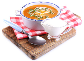 Carrot soup on cutting board isolated on white