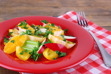 Waldorf salad with orange on plate on table close up