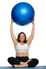 fat woman practicing yoga with blue ball