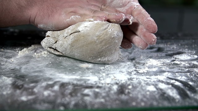 Kneading the dough with both hands in slow motion