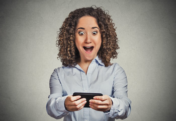 Shocked girl looking at phone bad news wow face expression