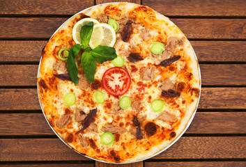Delicious italian pizza served on wooden table