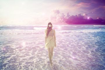 woman walking on dreamy beach enjoying ocean view