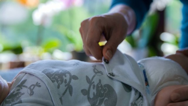 Hands stroking baby's feet
