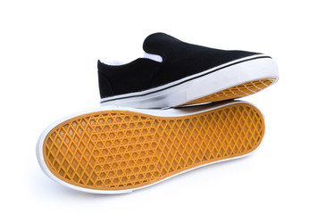 pair of black sneakers on white