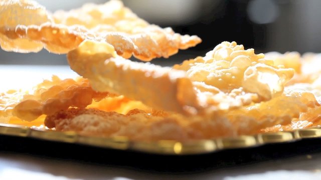 hands of pastry chef prepares the crostoli