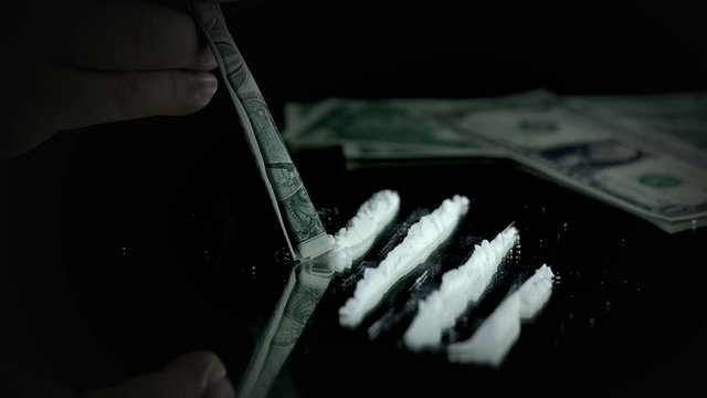 Sniffing cocaine with a dollar bill