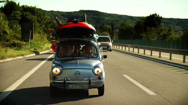 HD1080p: Family car filled with stuff for children play on the road toward summer holidays