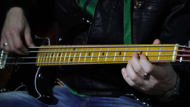 close up shot of musican playing guitar