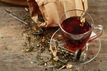Beautiful vintage composition with herbal tea, on wooden table