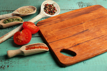 Different spices and herbs with cutting board