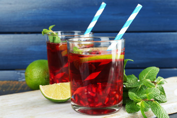 Pomegranate drink in glasses with slices of lime and mint