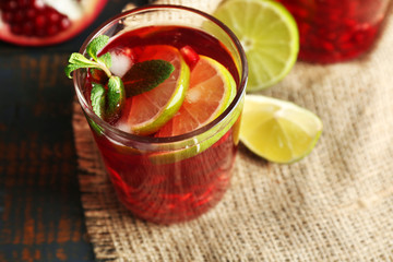 Pomegranate drink in glasses with slices of lime and mint