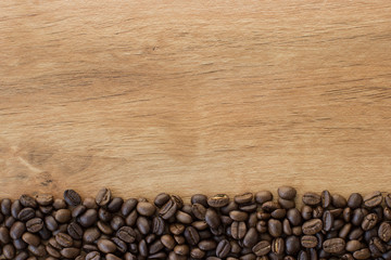 Coffee beans on wood background