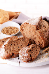 Tasty bread on table on light background
