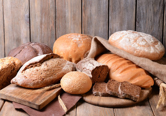 Different bread on table on wooden background