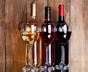 Different wine on table on wooden background